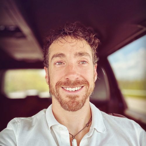 "Ben Short is a 200hr CYT who has been teaching yoga full time since 2015, with well over 2500 hours of teaching experience! Ben is a versatile teacher, enjoying sharing Vinyasa or Hatha, Restorative or Yin, even Hot Yoga. He’s noted for his warm positivity, detailed instruction particularly excellent for beginners, and compassionate delivery empowering all to feel comfortable and focused. Ben is also an accomplished musician and composer. Bringing those two worlds together, Ben offers live musical accompaniment for yoga classes that is truly special, uniquely able to flow the music with the practice, often described as downright magical! And come festival time, Ben loves to share his passion for astronomy and stargazing, offering fun and interactive nighttime workshops teaching and identifying the night sky! "